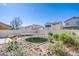 Landscaped backyard featuring a trampoline, rock garden, and perimeter fence for privacy at 4429 E Azure Ave, Las Vegas, NV 89115