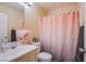 Bathroom featuring patterned wallpaper and a charming pink shower curtain at 4429 E Azure Ave, Las Vegas, NV 89115