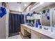 Bathroom featuring long vanity with dual sinks and a walk-in shower at 4429 E Azure Ave, Las Vegas, NV 89115