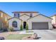 Charming two-story home featuring a well-kept lawn, an attached two-car garage, and desert landscaping at 4429 E Azure Ave, Las Vegas, NV 89115