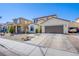 Two-story home with attached two-car garage, xeriscaped front yard and paved driveway at 4429 E Azure Ave, Las Vegas, NV 89115