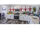 Bright kitchen featuring white cabinets with red ribbon decor and stainless steel appliances at 4429 E Azure Ave, Las Vegas, NV 89115