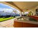 Relaxing hot tub under a covered patio with outdoor seating and artificial grass at 4471 Wisconsin Ave, Las Vegas, NV 89104