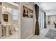 Well-lit half bathroom with a pedestal sink and decorative mirror at 4537 Cloudrest Peak St, North Las Vegas, NV 89031