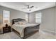 Bedroom featuring a black sleigh bed, carpet flooring, and three windows at 4537 Cloudrest Peak St, North Las Vegas, NV 89031