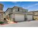 Modern townhome featuring a two-car garage, neutral paint, and clean landscaping at 4537 Cloudrest Peak St, North Las Vegas, NV 89031