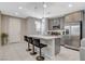 Open-concept kitchen with quartz countertop island and barstool seating at 4537 Cloudrest Peak St, North Las Vegas, NV 89031