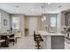 Bright eat-in kitchen featuring a large island with a sink and breakfast bar with seating at 4537 Cloudrest Peak St, North Las Vegas, NV 89031