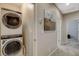 Convenient laundry room with stacked washer and dryer near the bedrooms at 4537 Cloudrest Peak St, North Las Vegas, NV 89031