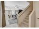 Cozy living area showcasing a staircase leading upstairs and seamlessly flows into the kitchen and dining area at 4537 Cloudrest Peak St, North Las Vegas, NV 89031