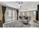 Open-concept living area with a patio view, neutral decor, and modern lighting at 4537 Cloudrest Peak St, North Las Vegas, NV 89031