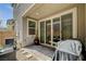Covered patio featuring tile pavers, a plant, and access to the home via sliding glass doors at 4537 Cloudrest Peak St, North Las Vegas, NV 89031