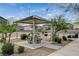 Picnic area with covered tables, grills, landscaped surroundings, and scattered shade trees at 4537 Cloudrest Peak St, North Las Vegas, NV 89031