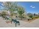 Community playground with green benches, a slide, shade trees, and well-maintained landscaping at 4537 Cloudrest Peak St, North Las Vegas, NV 89031