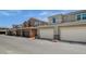 Street view of modern townhomes with attached garages and well-maintained landscaping on a sunny day at 4537 Cloudrest Peak St, North Las Vegas, NV 89031