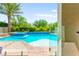 View of inground pool and spa with a lush landscape and palm tree at 454 Rosina Vista St, Las Vegas, NV 89138