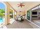 Covered patio, dining and outdoor kitchen overlooking a pool and lush landscaping at 454 Rosina Vista St, Las Vegas, NV 89138