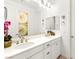 Bright bathroom with double sink vanity, flower decor, and large mirror at 454 Rosina Vista St, Las Vegas, NV 89138