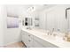 This bathroom has dual sinks, white cabinets, and decorative wall art at 454 Rosina Vista St, Las Vegas, NV 89138