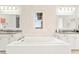 Modern bathroom features a soaking tub with dual sinks and tile accents at 454 Rosina Vista St, Las Vegas, NV 89138
