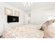 Comfortable bedroom with mounted TV, closet and eye-catching light fixture at 454 Rosina Vista St, Las Vegas, NV 89138