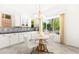 Charming breakfast nook features white seating, a stylish chandelier, and views of the beautifully landscaped backyard at 454 Rosina Vista St, Las Vegas, NV 89138