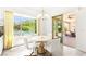 Bright breakfast nook features neutral decor, natural light, and views of the backyard oasis through a large window at 454 Rosina Vista St, Las Vegas, NV 89138