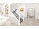 Elegant foyer featuring a staircase with white banisters and grey carpet runners at 454 Rosina Vista St, Las Vegas, NV 89138