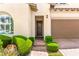 Charming front entrance with arched window, lush landscaping, and brick pathway at 454 Rosina Vista St, Las Vegas, NV 89138