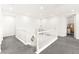 This carpeted hallway has white walls, a white banister, and access to other rooms at 454 Rosina Vista St, Las Vegas, NV 89138