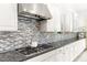 Kitchen with white cabinets, granite countertops, and a tile backsplash at 454 Rosina Vista St, Las Vegas, NV 89138