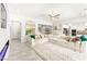 Bright living room with a large sectional sofa and tile flooring at 454 Rosina Vista St, Las Vegas, NV 89138