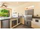 Well-equipped outdoor kitchen with stainless steel grill, ample countertop space, and convenient storage at 454 Rosina Vista St, Las Vegas, NV 89138