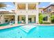 Stunning backyard showcasing a large pool with built-in steps and lush landscaping at 454 Rosina Vista St, Las Vegas, NV 89138