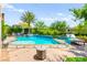A backyard swimming pool featuring a spa, surrounding landscaping, and a cozy lounging area, perfect for relaxation at 454 Rosina Vista St, Las Vegas, NV 89138