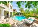 A beautiful backyard featuring a refreshing swimming pool with a spa, glass fencing, and lush landscaping for privacy at 454 Rosina Vista St, Las Vegas, NV 89138