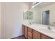 Bathroom with double sink vanity, granite counters and large framed mirror at 4744 Deer Forest Ave, Las Vegas, NV 89139
