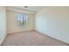 Comfortable bedroom featuring neutral carpet and light walls, and window overlooking the street at 4744 Deer Forest Ave, Las Vegas, NV 89139