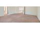 Spacious bedroom featuring neutral carpeting with views to the attached bathroom and closet at 4744 Deer Forest Ave, Las Vegas, NV 89139