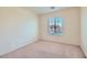 Cozy bedroom featuring neutral carpet and light walls, and window overlooking the street at 4744 Deer Forest Ave, Las Vegas, NV 89139