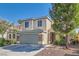 Attractive two-story home with a well-maintained lawn and appealing architectural details at 4744 Deer Forest Ave, Las Vegas, NV 89139