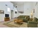 Cozy living room with comfortable green sofa, armchair, and traditional rug at 4744 Deer Forest Ave, Las Vegas, NV 89139