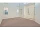 Living room with soaring ceilings, neutral carpet and paint and a large front door entry at 4744 Deer Forest Ave, Las Vegas, NV 89139