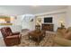 Cozy living room with television and stairs to the second floor at 4744 Deer Forest Ave, Las Vegas, NV 89139