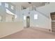 Spacious living room with soaring ceilings, neutral carpet and paint, a stairway, and a view of the front entry at 4744 Deer Forest Ave, Las Vegas, NV 89139