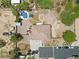 Aerial view of a property featuring a pool, large patio, and ample parking space at 4883 Grey Mesa St, Las Vegas, NV 89149