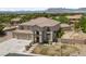 Expansive property showcasing a tile-roofed home with a large driveway and mountain views at 4883 Grey Mesa St, Las Vegas, NV 89149