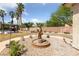 Backyard landscape featuring a decorative water fountain, gravel, and desert flora at 4883 Grey Mesa St, Las Vegas, NV 89149