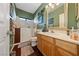 Well-lit bathroom with a vanity, mirror, and accessible walk-in shower at 4883 Grey Mesa St, Las Vegas, NV 89149