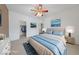 Bedroom featuring a bed with blue bedding, ceiling fan and artwork on the wall at 4883 Grey Mesa St, Las Vegas, NV 89149